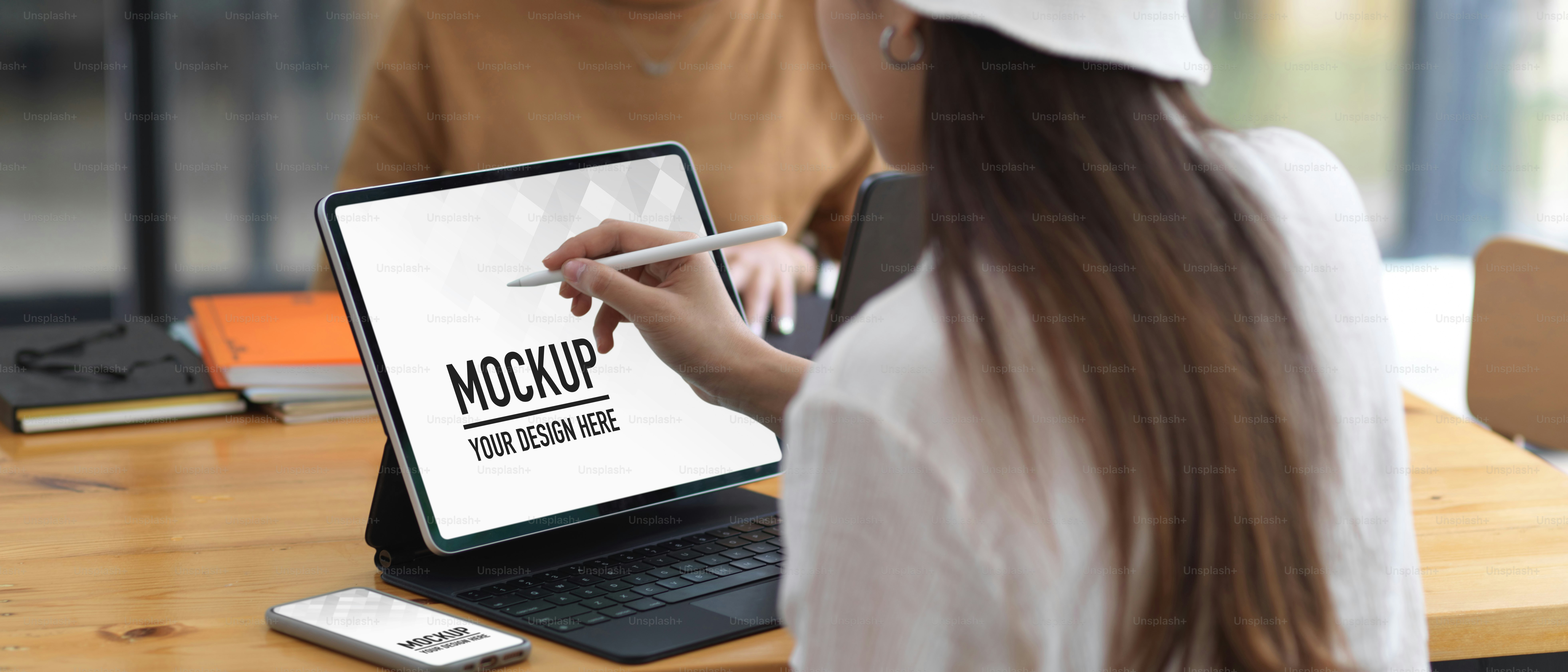 Female college student doing assignment with tablet and smartphone, include clipping path